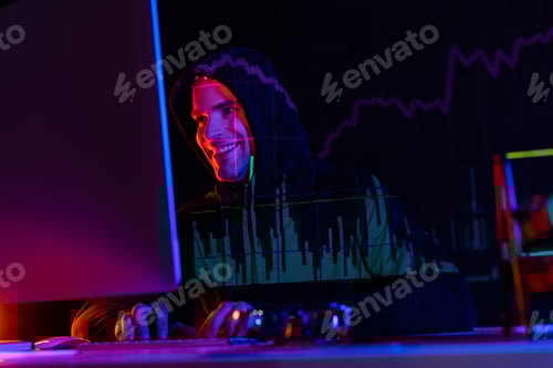 Preview: Smiling hacker using computer near eyeglasses and reflection of charts on black background