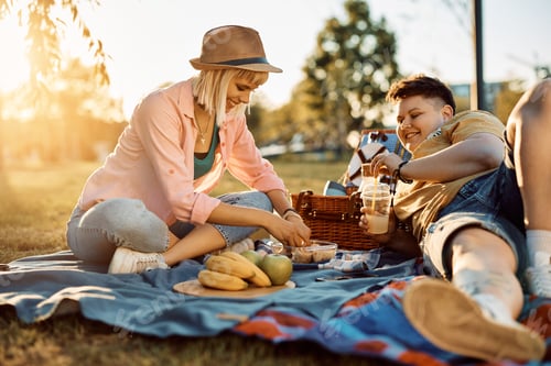 Preview: Happy woman enjoying in picnic day with her girlfriend in nature.