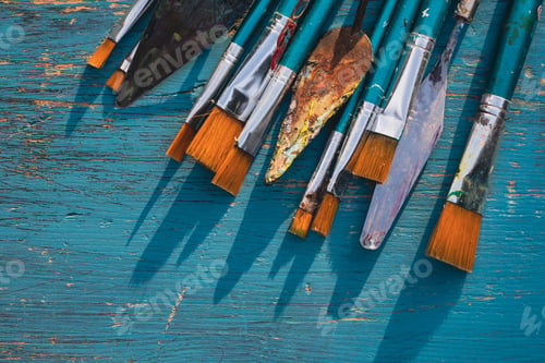 Preview: Paint brushes with palette knives on blue background