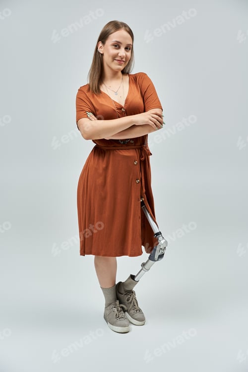Preview: Confident Woman in Orange Dress With Prosthetic Leg
