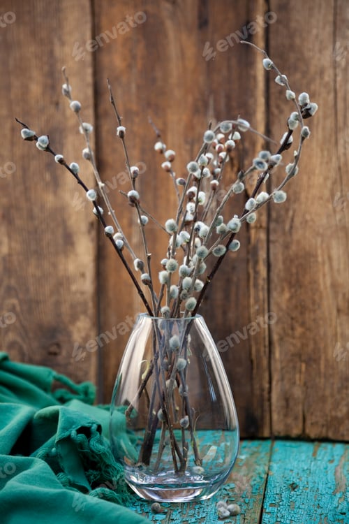 Preview: Sprigs of willow in a glass vase. Easter still life. Bouquet on a wooden table. Background for