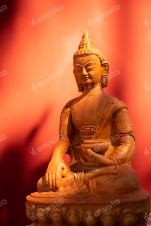 Preview: Closeup shot of the statue of Buddha under the red light