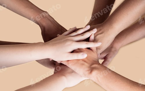 Preview: joined hands of multiethnic women, beige background