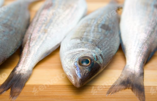 Preview: Fresh Fish on Wooden Cutting Board Close-up