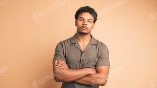 Preview: Confident man looking at camera in beige studio
