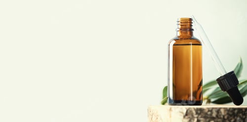 Preview: Banner with Blank transparent amber glass essential oil bottle
