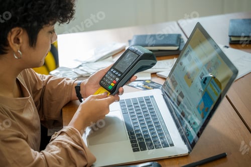 Preview: Woman shopping online with notebook using credit card for buy and payment at home.