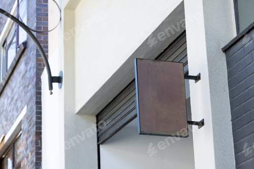 Preview: Blank sign fixed to building wall with copy space