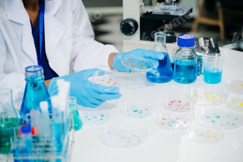 Preview: Young scientists conducting research investigations in a medical laboratory, a researcher