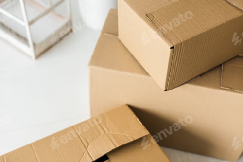 Preview: Brown cardboard boxes on light surface at home