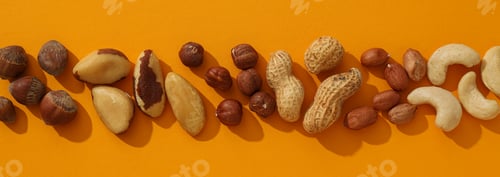 Preview: Assortment of different nuts on an orange background