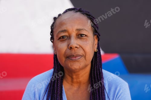 Preview: Portrait of african senior woman looking serious on camera in the city