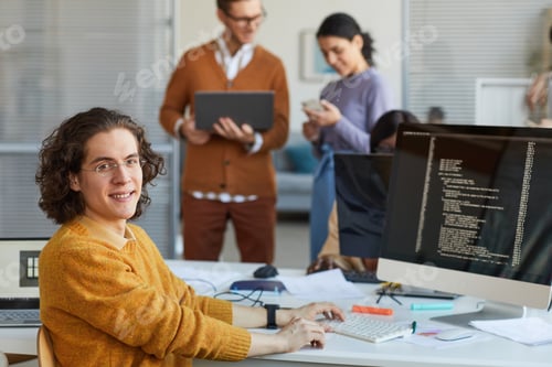 Preview: Young Man Programming Software in Office