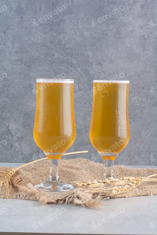 Preview: Two glasses of beer with wheat on sackcloth