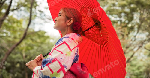 Preview: Park, umbrella and woman with fashion, thinking and travel with smile in woods. Street, kimono and