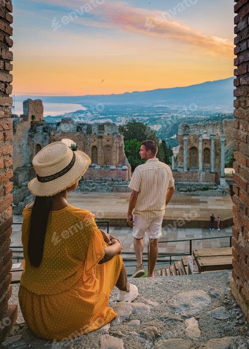 Preview: Taormina Sicily, couple watching sunset at the Ruins of the Ancient Greek Theater Taormina, Sicily