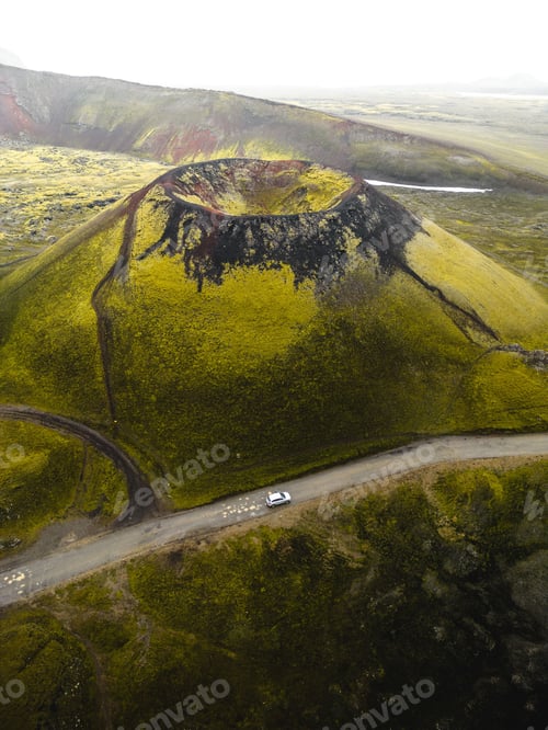 Preview: Aerial view of Laki volcano surrounded by greenery hills with road in Iceland