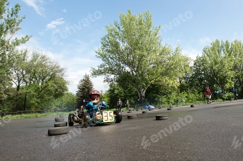 Preview: Karting - driver in helmet on kart circuit