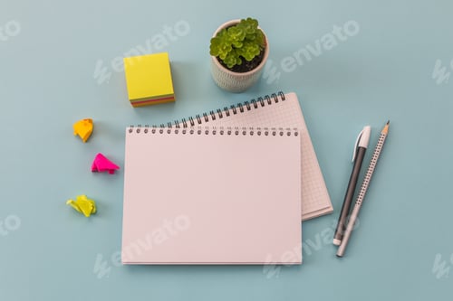 Preview: Notebooks, pen, stickers on a blue background. Conceptual image