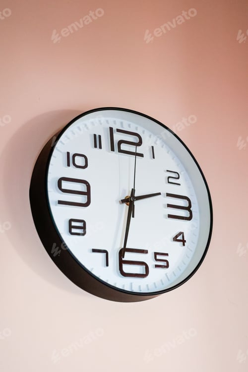 Preview: Wall clock with a white face and brass hands, ticking away the minutes