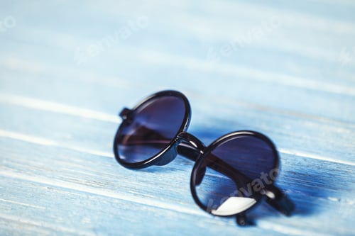 Preview: Glasses on blue wooden table.