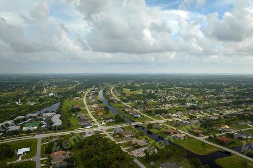 Preview: Aerial landscape view of suburban private houses between green palm trees in Florida