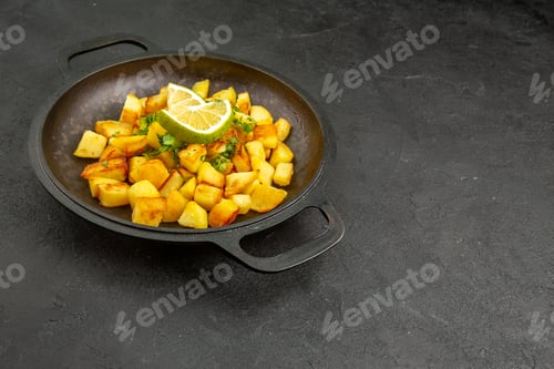 Preview: front view fried potatoes inside pan with lemon slices on dark background photo cuisine meal