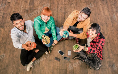 Preview: Group of hipster best friends with smartphones in grungy alternative location