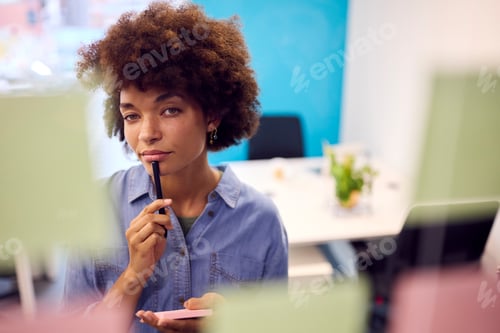 Preview: Young Businesswoman Working In Modern Office Looking At Transparent Screen With Sticky Notes
