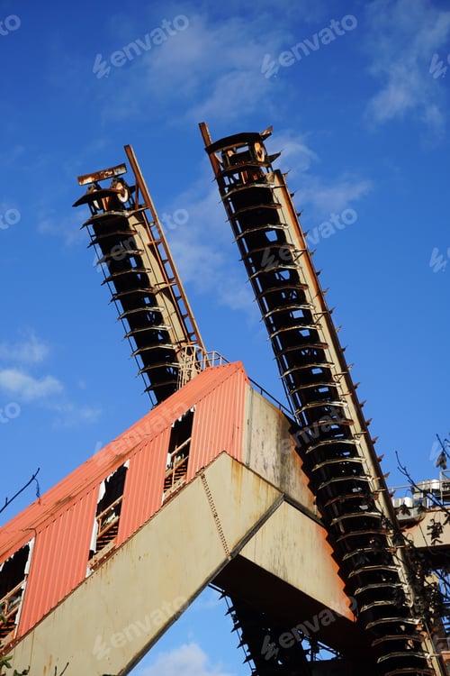 Preview: Vertical shot of an old chain conveyor against a blue sky