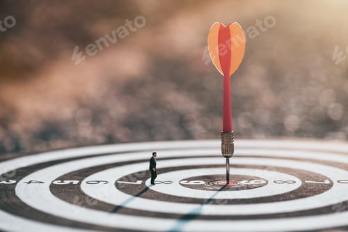 Preview: Businessman standing lookup red dart arrow hitting target centre dartboard