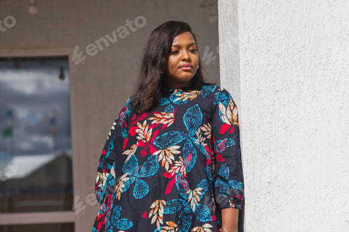 Preview: African american woman relaxing and enjoying sun while standing at terrace or balcony at sunlight at