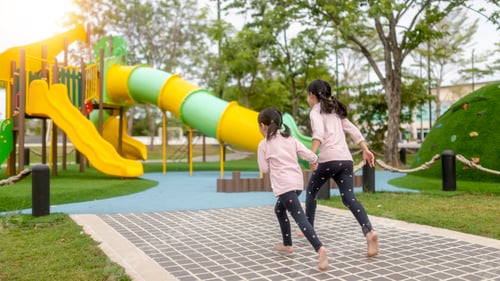 Preview: Asian little girl enjoys playing in a children playground, Outdoor portrait