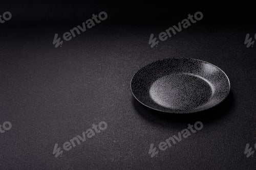 Preview: Empty round black plate for food, kitchen utensils on dining table. Empty plate