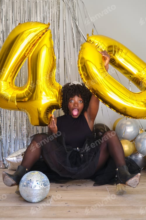 Preview: African woman in a 40 birthday party with 40 birthday golden balloons.