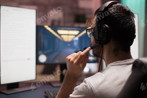 Preview: Man playing shooter games with other players late at night