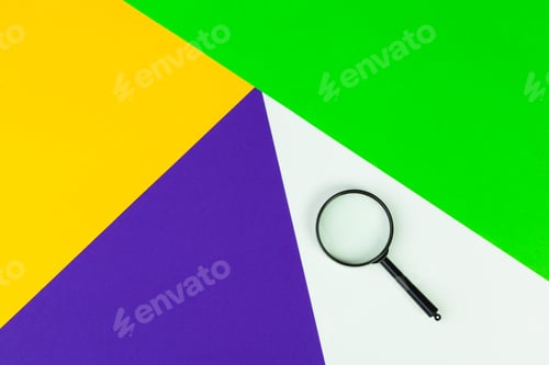 Preview: Magnifying glass on bright colored background flat lay