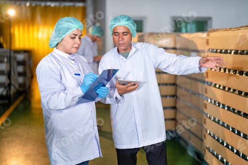 Preview: In warehouse quality control team checking drinking bottle stack on pallet before delivery