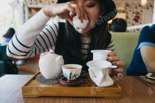 Preview: Woman sipping hot tea