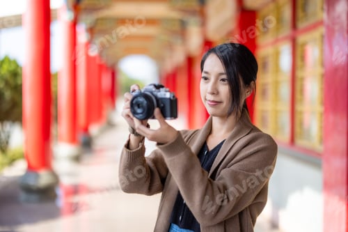 Preview: Travel woman use digital camera to take photo in Chinese temple