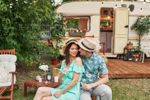 Preview: Romantic Couple Relaxing Near Travel Trailer in Nature