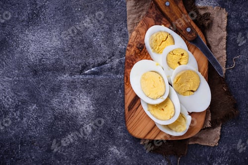 Preview: Boiled sliced chicken eggs on cutting board