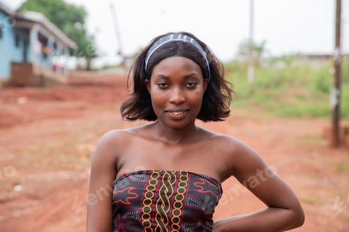 Preview: Portrait of a young African woman outdoors wearing a traditional dress