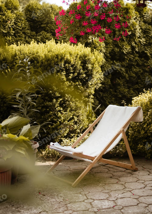 Preview: Vertical shot of a folding chair surrounded by beautiful greenery and flowers