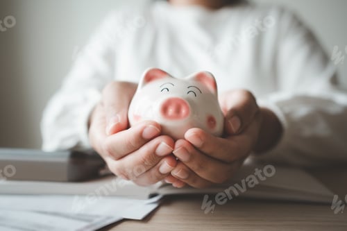 Preview: Money save concept woman put coin in piggy bank. Coin currency deposit for household expense.