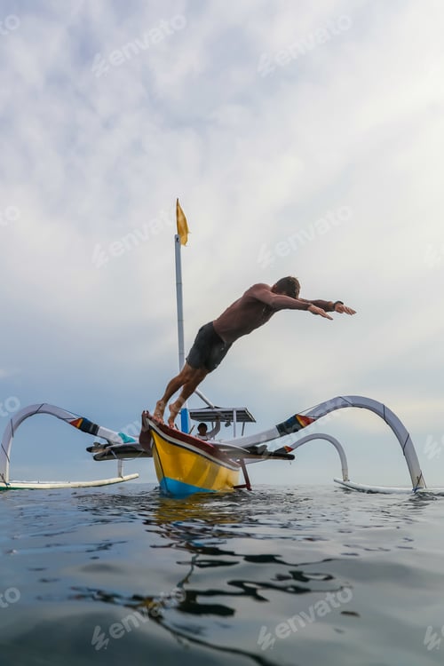 Preview: Man diving from boat in waving water