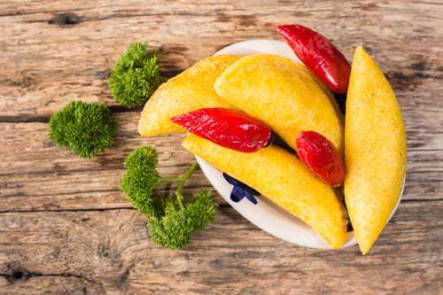 Preview: Empanadas and hot pepper on wooden background, traditional Colombian food