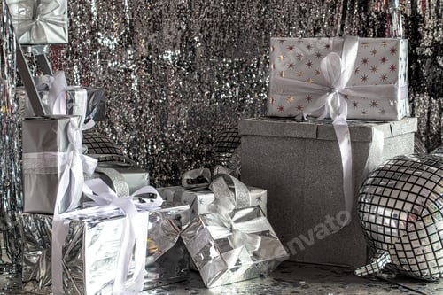 Preview: Silver festive Christmas boxes on a shiny background.