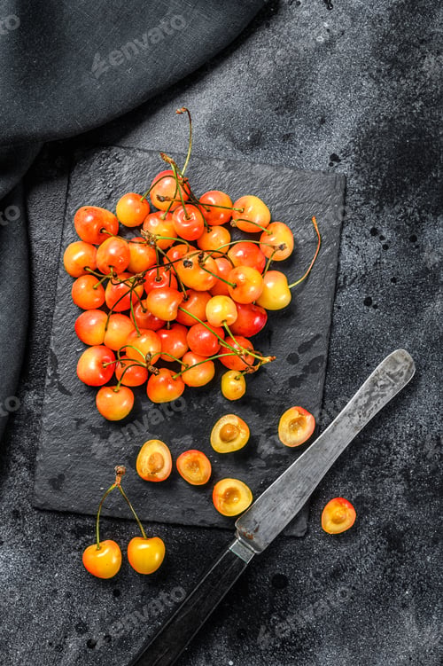 Preview: Mix of yellow and red ripe cherries. Black background. Top view
