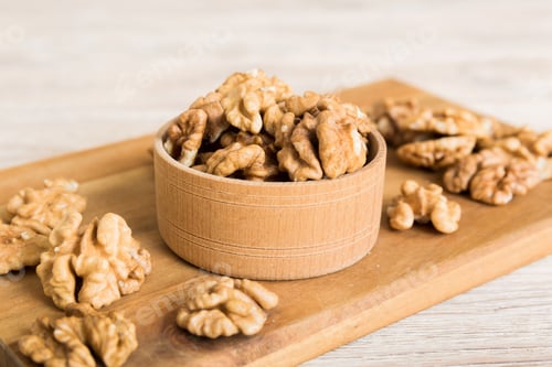 Preview: Fresh healthy walnuts in bowl on colored table background. Top view Healthy eating